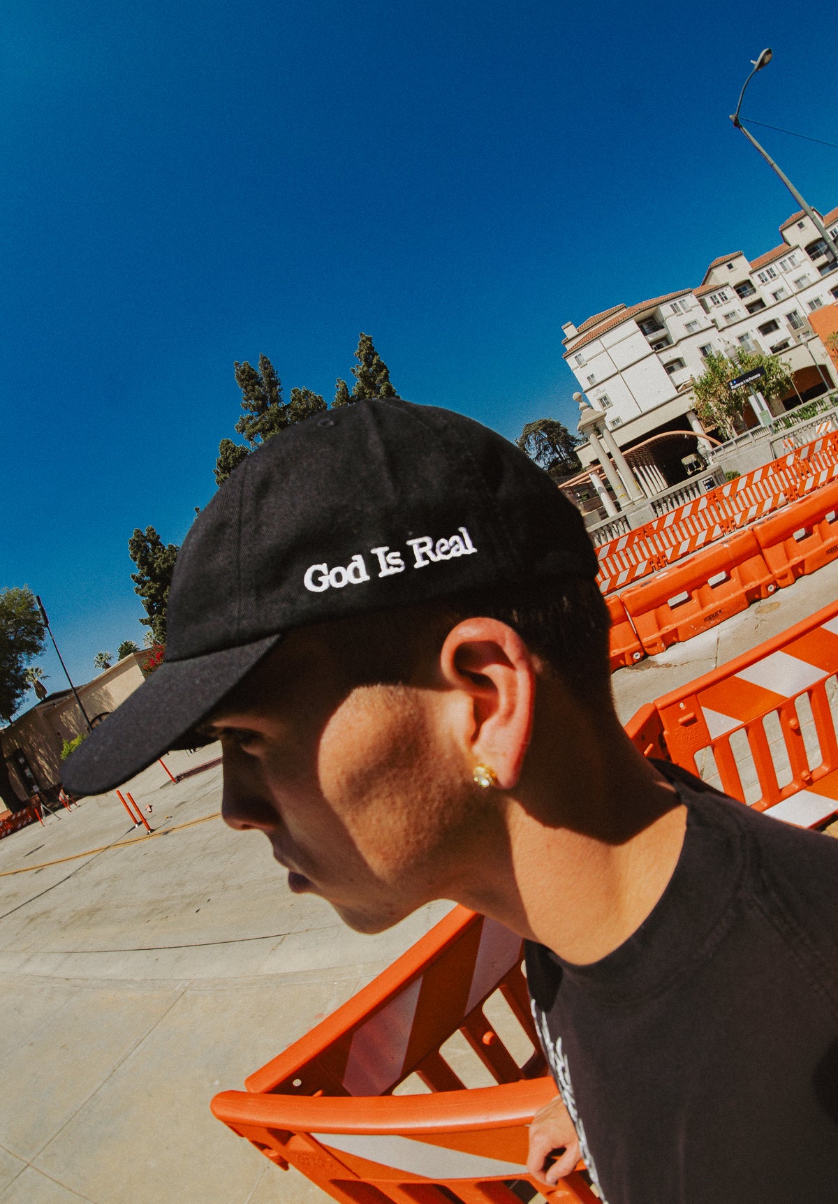 Model wearing black God Is Real dad hat outdoors