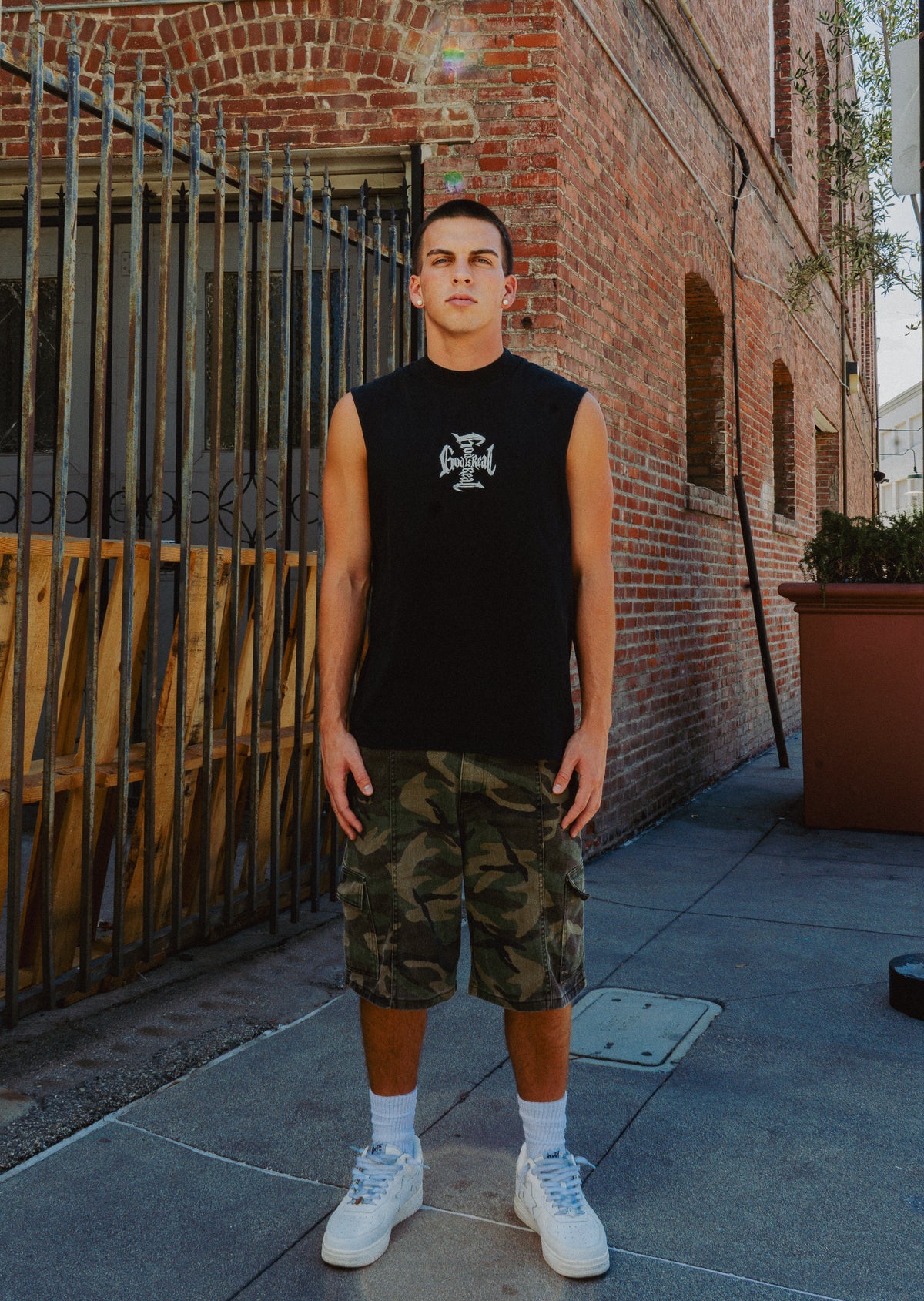 Model wearing black God Is Real cut-off tank, Christian streetwear